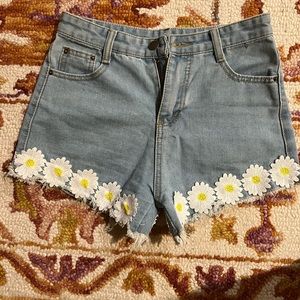 Size 0 Jean shorts with flower patches.